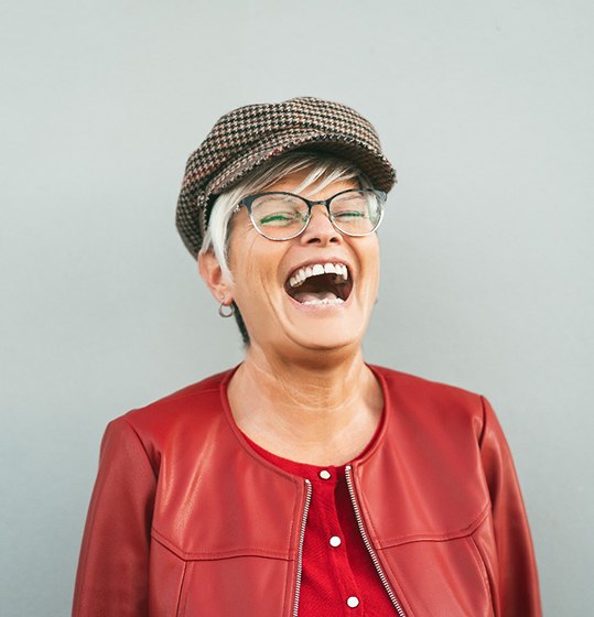a person wearing a red leather coat laughing