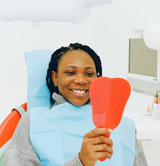 Dentist performing dental treatment on woman
